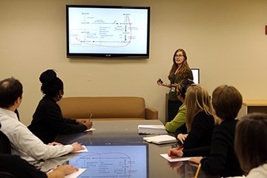 Staff from the MPC gather around a conference table.